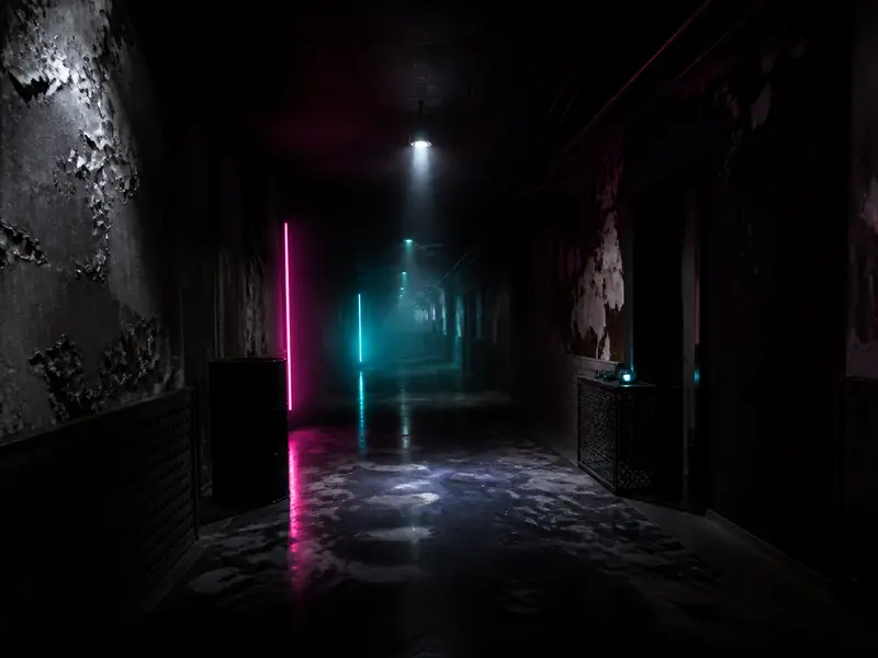 dark abandoned corridor with flickering light and peeling walls